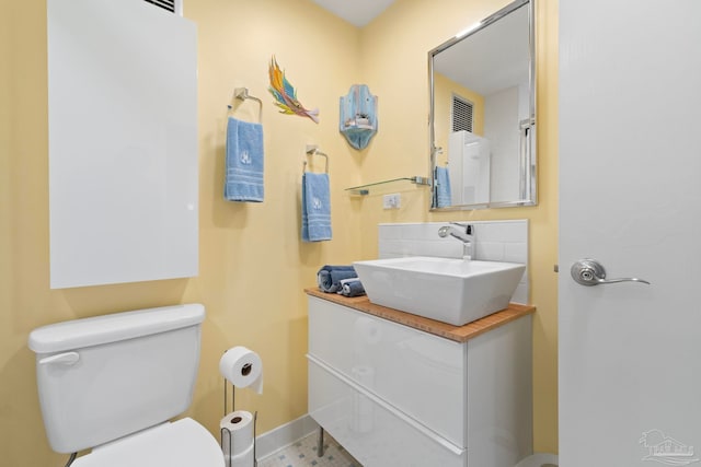 bathroom featuring vanity and toilet