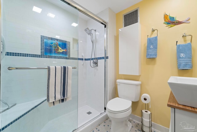 bathroom with toilet, an enclosed shower, vanity, and tile patterned floors