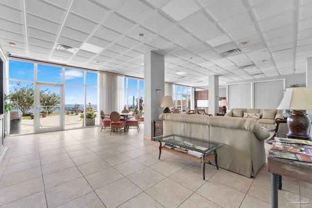 tiled living room featuring expansive windows