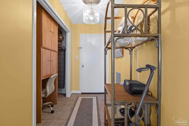 interior space with light tile patterned floors and an inviting chandelier