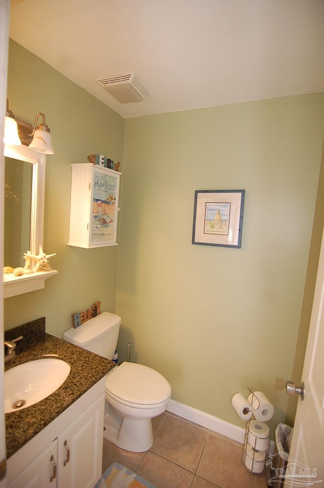 bathroom with vanity, toilet, and tile patterned flooring