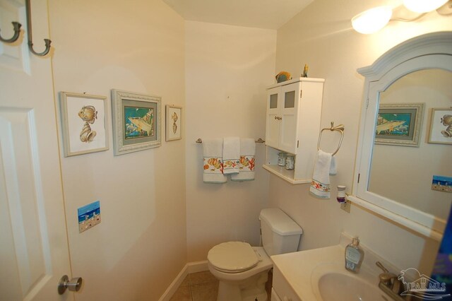 bathroom with tile patterned flooring, vanity, and toilet