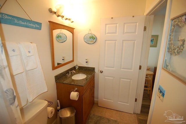 bathroom with tile patterned floors, vanity, and toilet