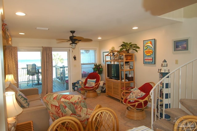 tiled living room with ceiling fan and a wealth of natural light