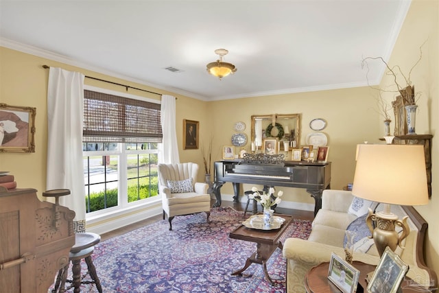 living room with baseboards, crown molding, and wood finished floors