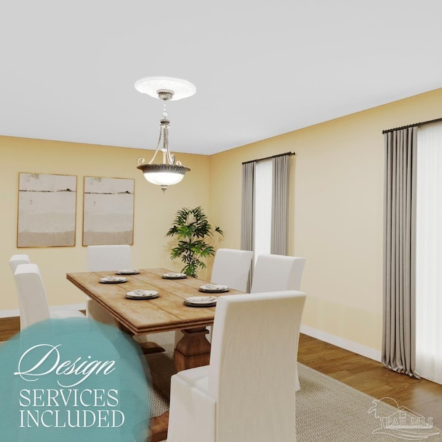 dining space featuring baseboards and wood finished floors