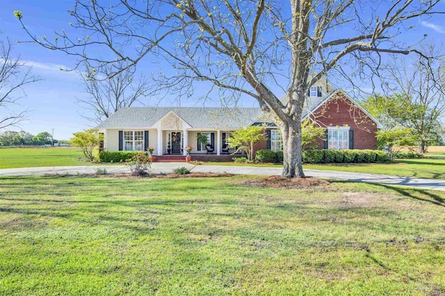 view of front of home with a front yard and a porch
