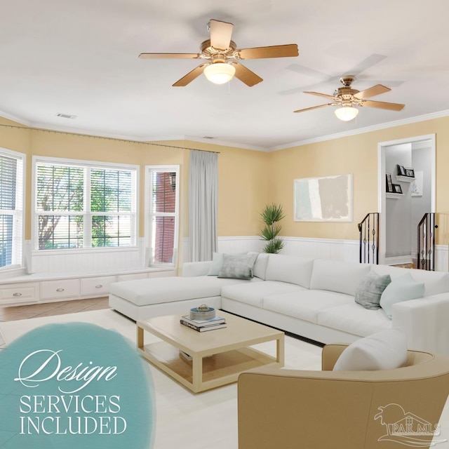 living area featuring a ceiling fan, wainscoting, ornamental molding, and visible vents