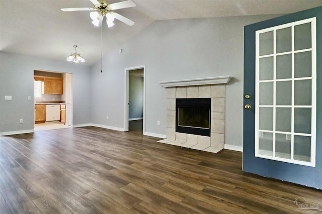 unfurnished living room featuring a fireplace, baseboards, ceiling fan, dark wood-style flooring, and vaulted ceiling