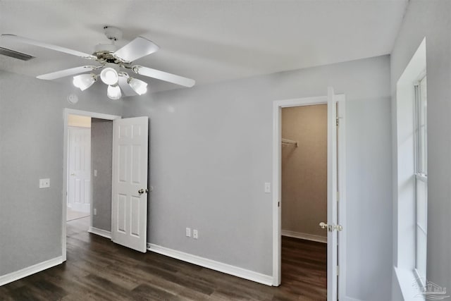 unfurnished bedroom featuring visible vents, baseboards, and wood finished floors