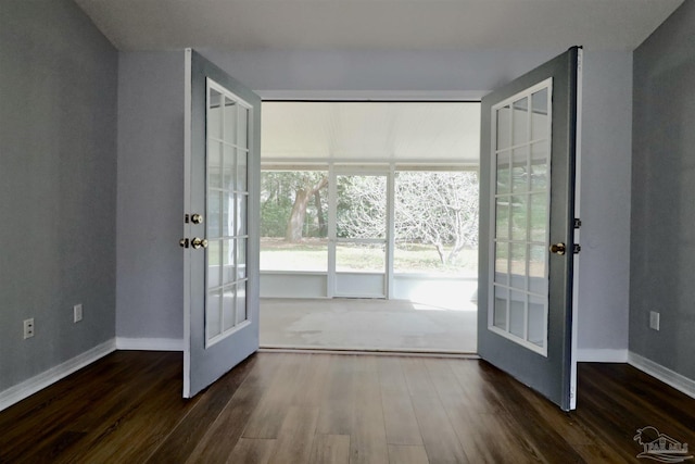 doorway to outside with french doors, baseboards, and dark wood finished floors