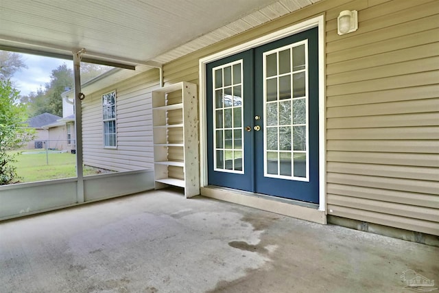 unfurnished sunroom featuring french doors