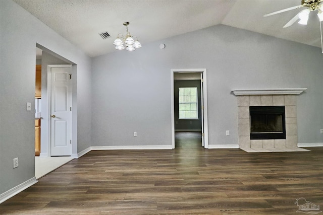 unfurnished living room featuring visible vents, wood finished floors, a fireplace, and vaulted ceiling