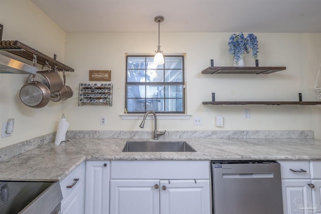 kitchen featuring open shelves, decorative light fixtures, stainless steel dishwasher, white cabinets, and a sink