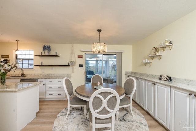 dining area with a chandelier and light wood-type flooring