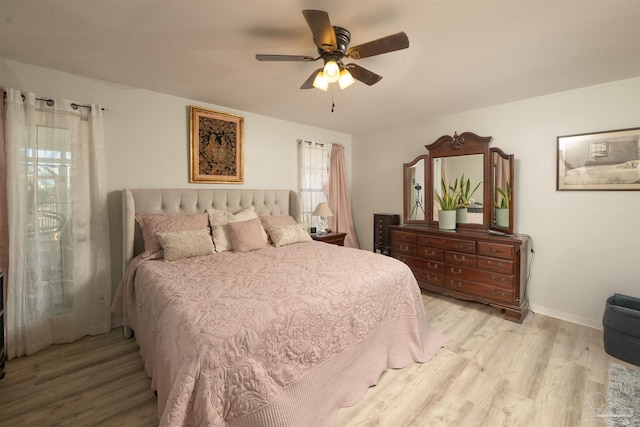 bedroom featuring a ceiling fan, wood finished floors, and baseboards