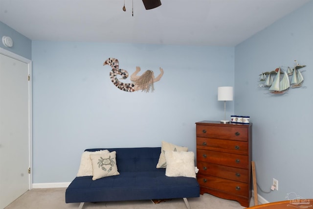 living area with baseboards and carpet