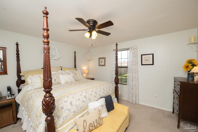 bedroom featuring baseboards, light colored carpet, and ceiling fan