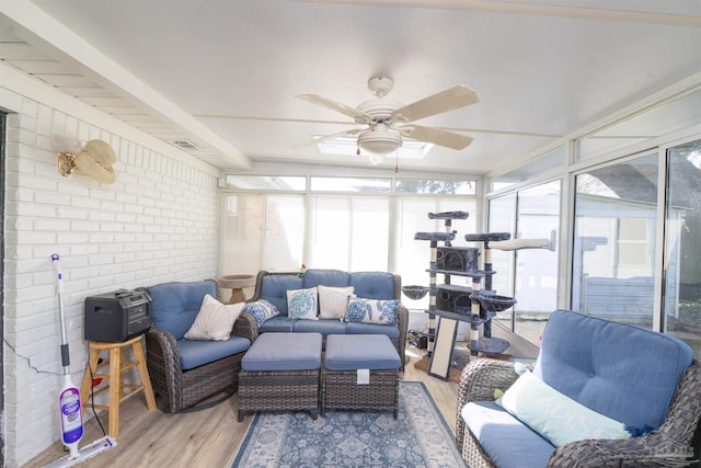 10870 Tara Dawn Cir, Pensacola, FL 32534 - sunroom / solarium with an outdoor hangout area, wood finished floors, ceiling fan, a wall of windows, and brick wall