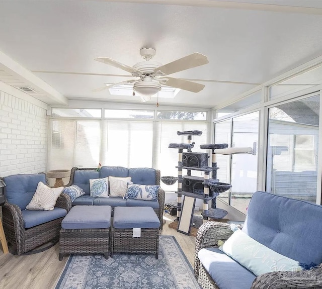 sunroom / solarium with a ceiling fan and visible vents