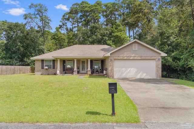 ranch-style home featuring a porch, a garage, and a front yard