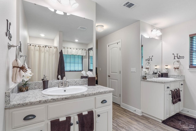 bathroom with hardwood / wood-style floors and vanity