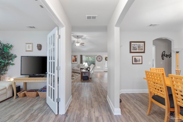 hall with light hardwood / wood-style flooring and french doors