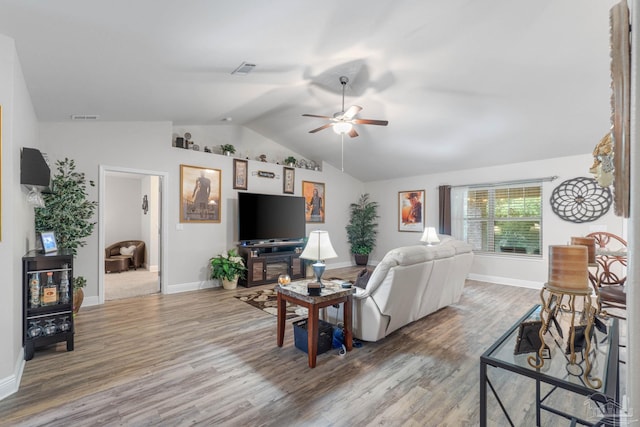 living room with vaulted ceiling, ceiling fan, and hardwood / wood-style flooring