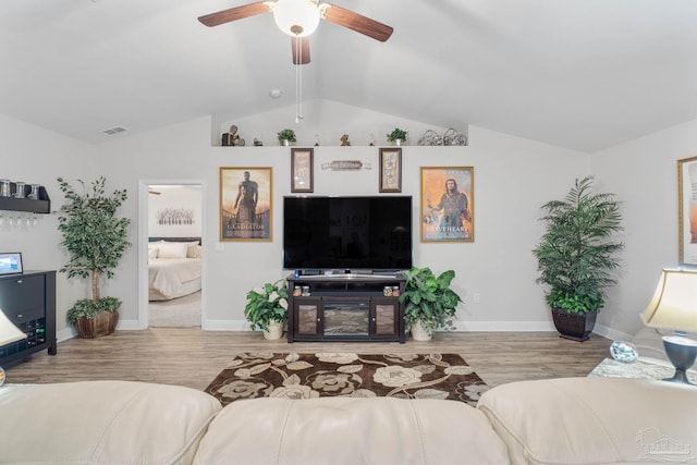 living room with vaulted ceiling, ceiling fan, and light hardwood / wood-style flooring