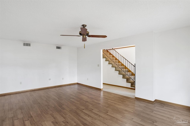 2821 Mandeville Ln, Pensacola, FL 32526 - spare room with ceiling fan, wood finished floors, stairway, and baseboards