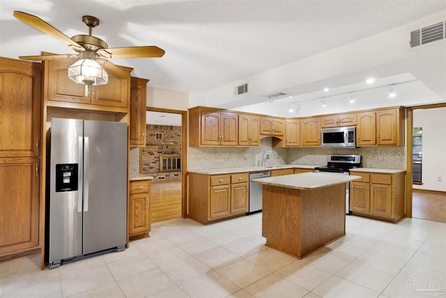 2821 Mandeville Ln, Pensacola, FL 32526 - kitchen featuring stainless steel appliances, tasteful backsplash, light countertops, and a kitchen island