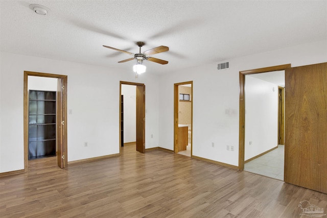 2821 Mandeville Ln, Pensacola, FL 32526 - spare room with wood finished floors, ceiling fan, baseboards, and a textured ceiling
