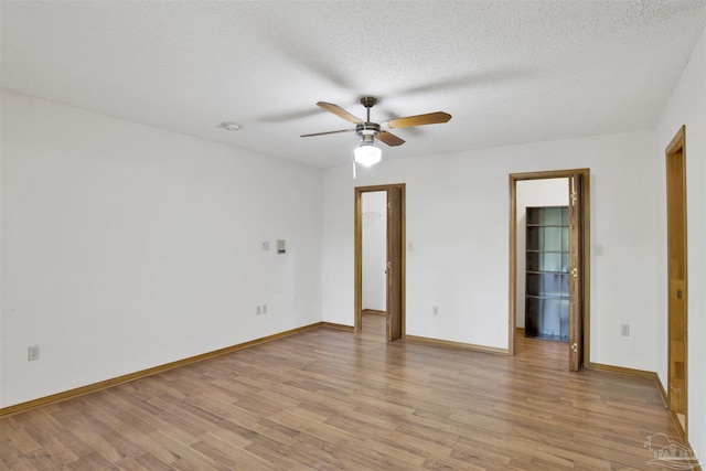 2821 Mandeville Ln, Pensacola, FL 32526 - unfurnished room featuring light wood-style floors, a ceiling fan, a textured ceiling, and baseboards