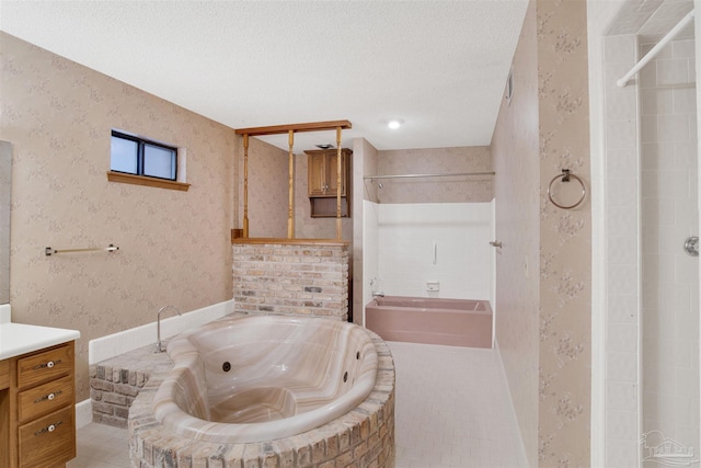 2821 Mandeville Ln, Pensacola, FL 32526 - full bath featuring tiled tub, a shower, vanity, and a textured ceiling