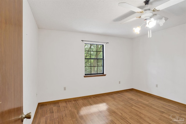 2821 Mandeville Ln, Pensacola, FL 32526 - unfurnished room with wood finished floors, ceiling fan, baseboards, and a textured ceiling