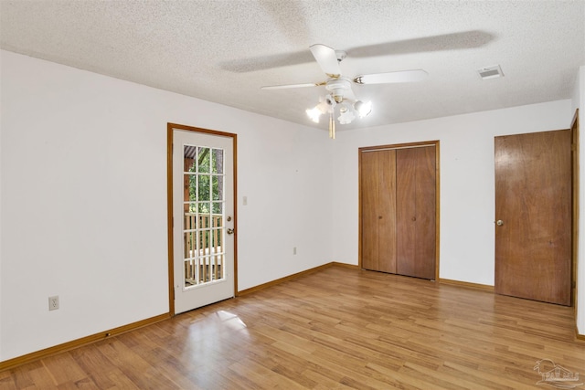 2821 Mandeville Ln, Pensacola, FL 32526 - unfurnished bedroom with light wood-style flooring, baseboards, a textured ceiling, and a ceiling fan