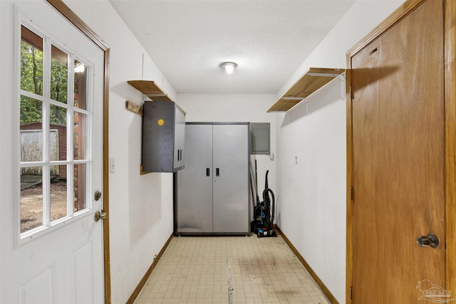 2821 Mandeville Ln, Pensacola, FL 32526 - clothes washing area featuring baseboards, light flooring, a textured ceiling, and electric panel