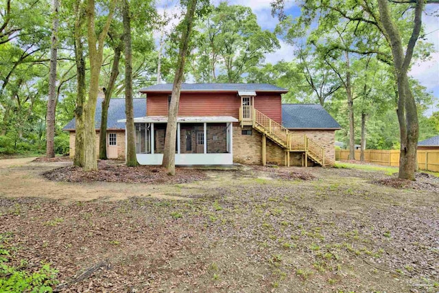 2821 Mandeville Ln, Pensacola, FL 32526 - back of property featuring a sunroom, stairway, and fence