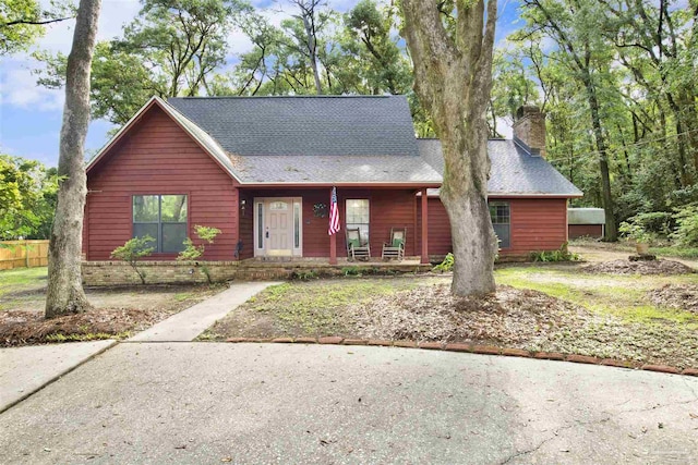 2821 Mandeville Ln, Pensacola, FL 32526 - view of front of property with a chimney, covered porch, and a shingled roof