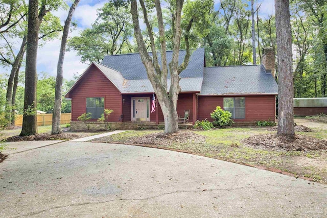 2821 Mandeville Ln, Pensacola, FL 32526 - rustic home with a chimney, fence, and a shingled roof
