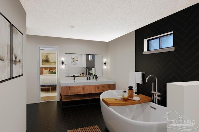 2821 Mandeville Ln, Pensacola, FL 32526 - ensuite bathroom featuring a soaking tub, vanity, and a textured ceiling