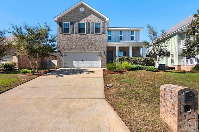 front of property featuring covered porch, a garage, and a front lawn