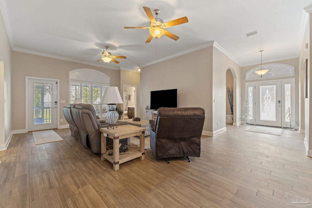 living room with ceiling fan, light wood-type flooring, and crown molding