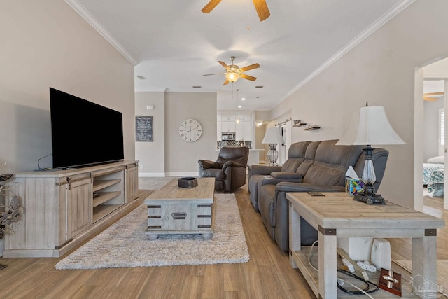 living room with light wood-type flooring, ceiling fan, and crown molding