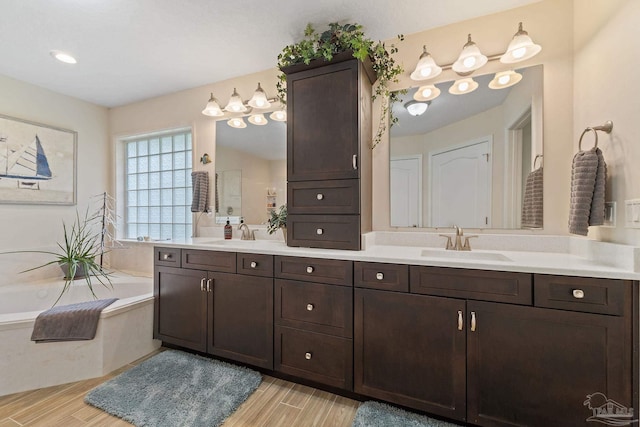 bathroom with a bathing tub, wood-type flooring, and vanity