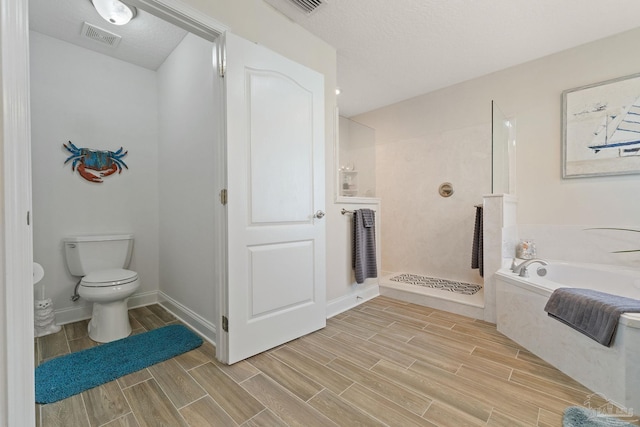 bathroom with shower with separate bathtub, a textured ceiling, and toilet