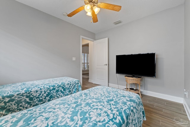 bedroom featuring ceiling fan and dark hardwood / wood-style floors