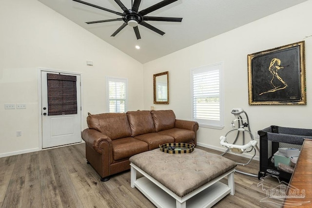 living room with wood finished floors, baseboards, vaulted ceiling, and ceiling fan