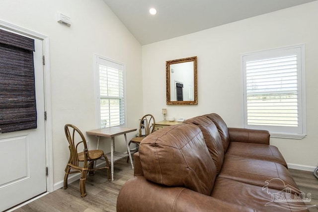 living area with baseboards, wood finished floors, vaulted ceiling, and recessed lighting