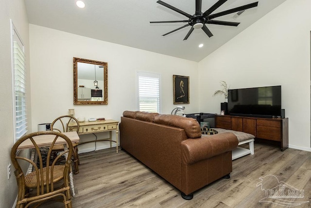 living room featuring light wood finished floors, baseboards, recessed lighting, a ceiling fan, and lofted ceiling
